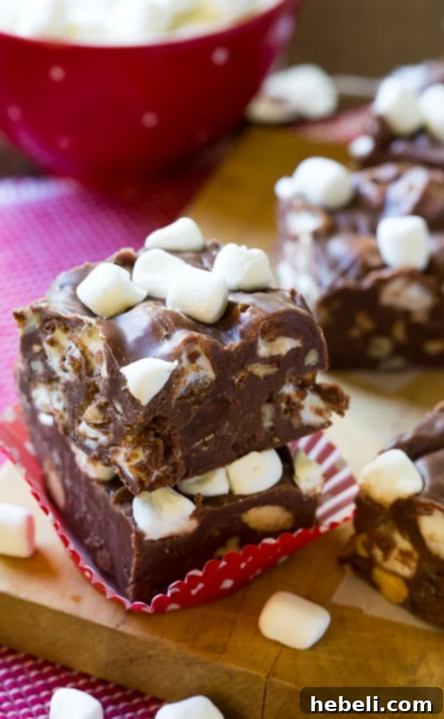 Close-up of freshly made Rocky Road Fudge, showcasing a generous amount of chopped almonds and mini marshmallows.