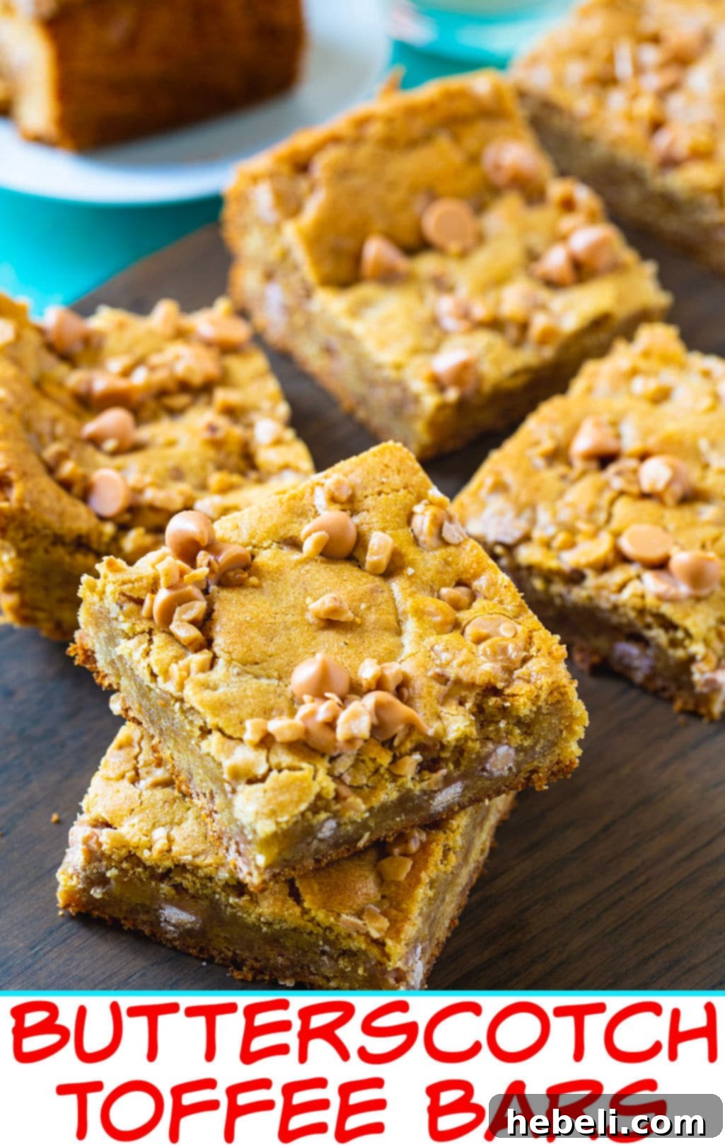 A close-up of Butterscotch Toffee Blondies on a wood cutting board, highlighting the rich, golden color and the inviting, studded surface with chips and bits.
