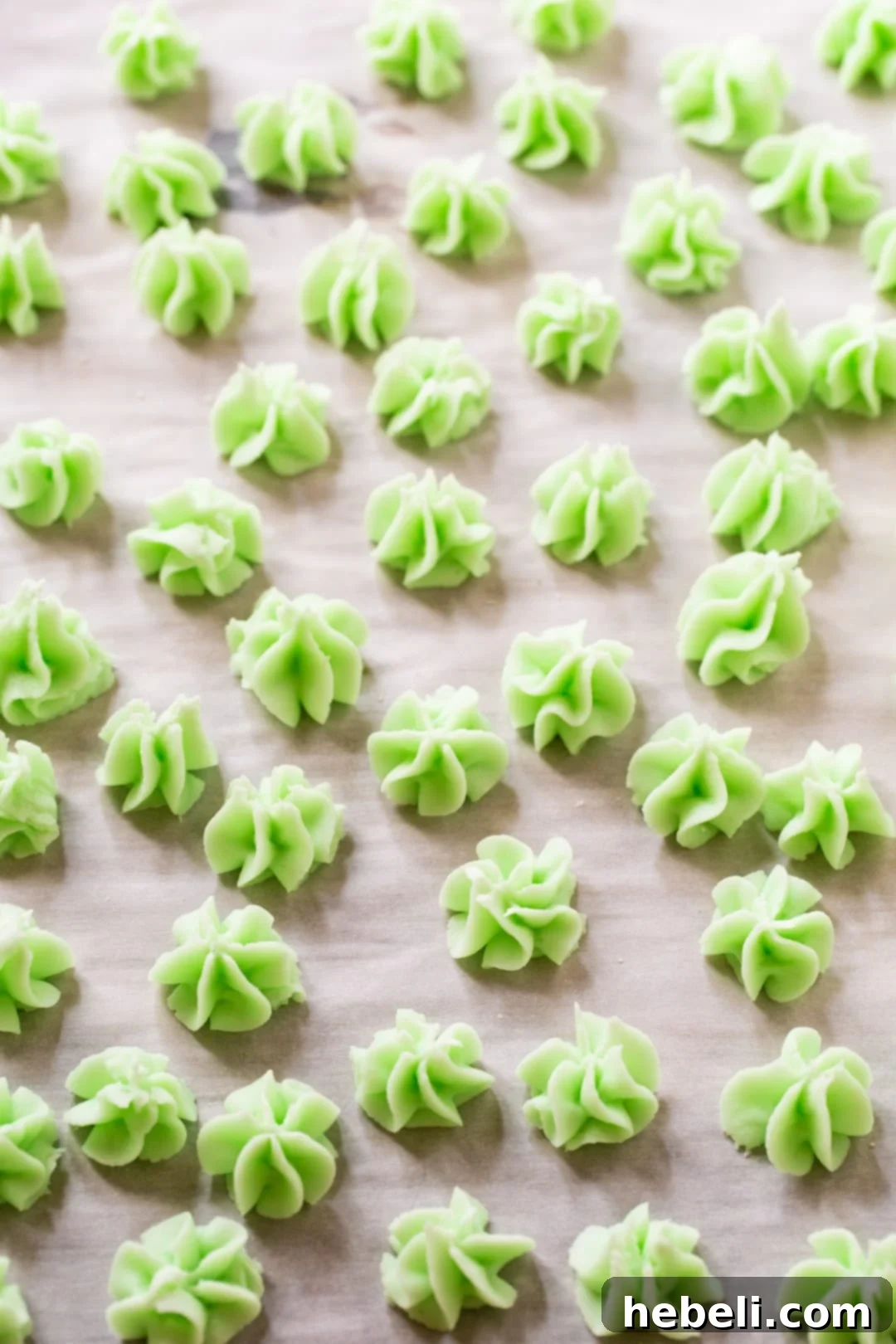 Cream Cheese Mints spread out on parchment paper, ready to be shaped and enjoyed.