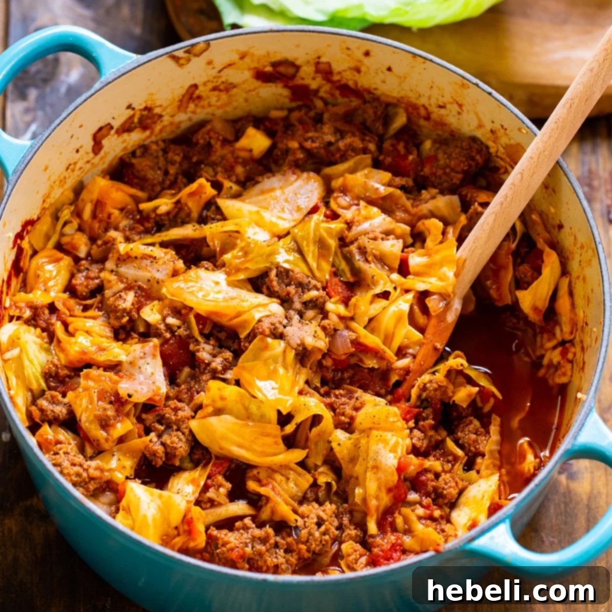 Hearty Unstuffed Cabbage Rolls simmering in a blue Dutch oven, ready to serve.