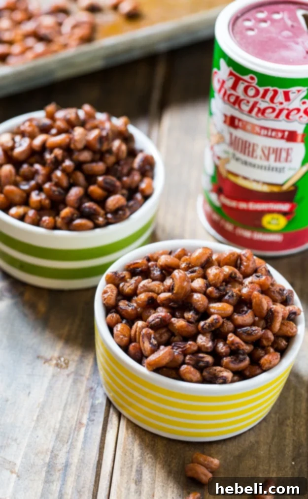 Crispy Roasted Black-Eyed Peas 5 A hand reaching for a bowl of perfectly roasted black-eyed peas, highlighting their crispy texture.