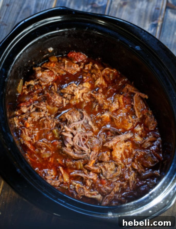 Cooked Slow Cooker Short Ribs in a rustic serving pot, ready to be sauced