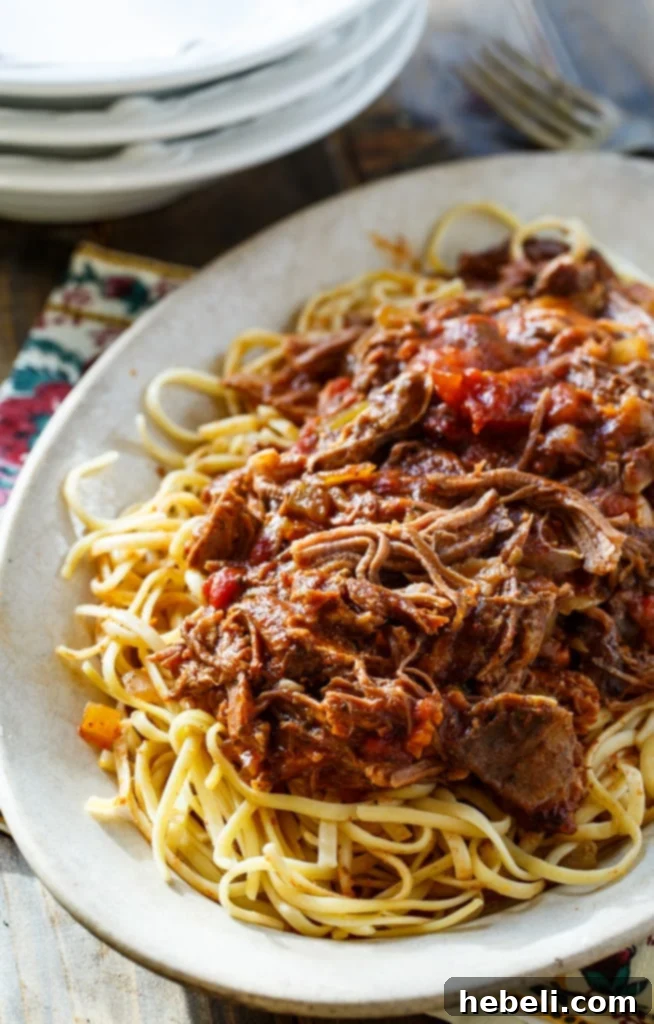 Slow Cooker Short Rib Sauce generously served over creamy mashed potatoes