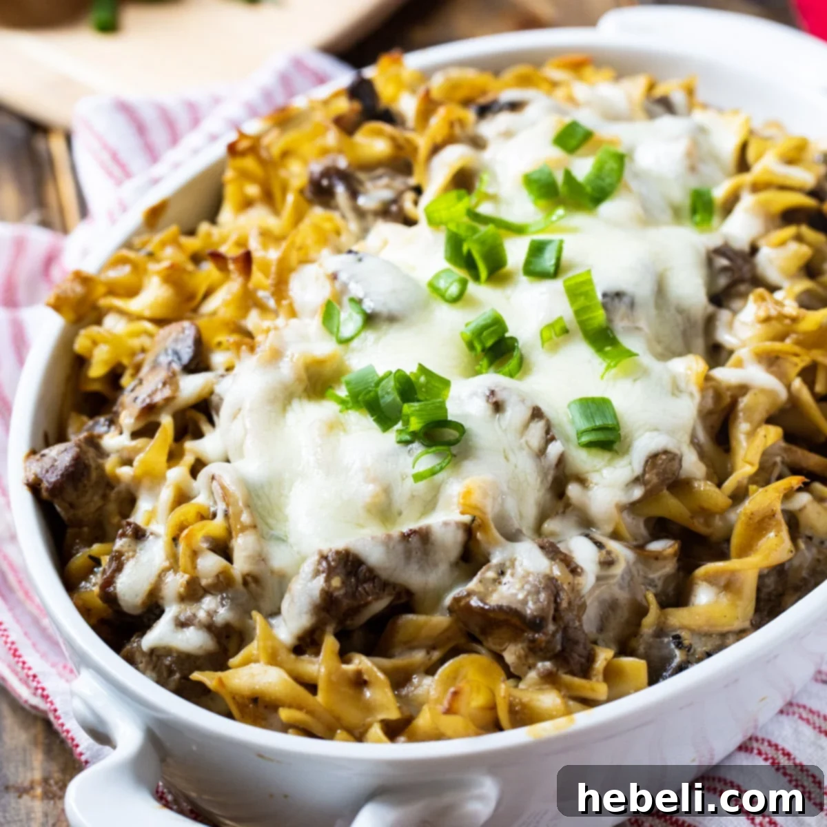 Beef Stroganoff Casserole covered with melted cheese in a casserole dish, ready to be served.