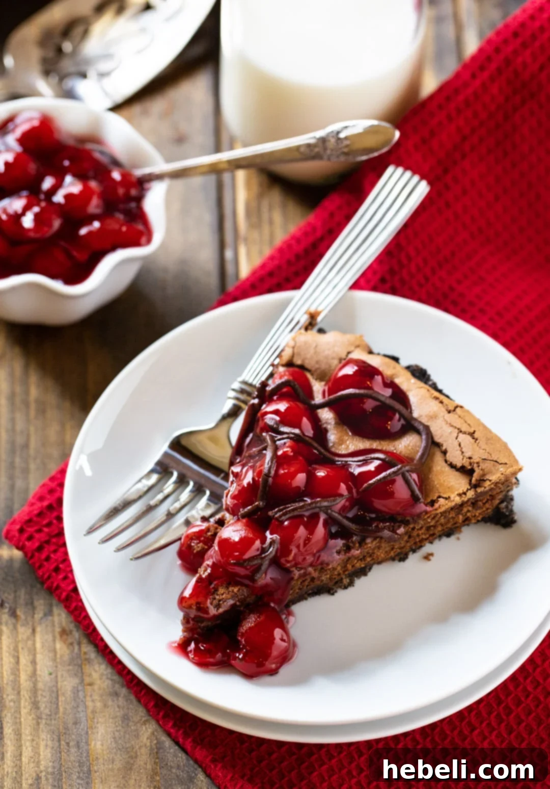 A perfectly portioned slice of Black Forest Tart presented on a plate.