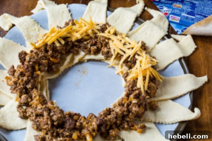 Fiesta Taco Wreath 4 Preparing the Taco Ring: crescent roll triangles laid out in a sunburst pattern on a baking sheet, ready for the filling.