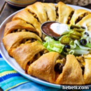 A freshly baked Taco Ring, golden brown with melted cheese and a savory filling.