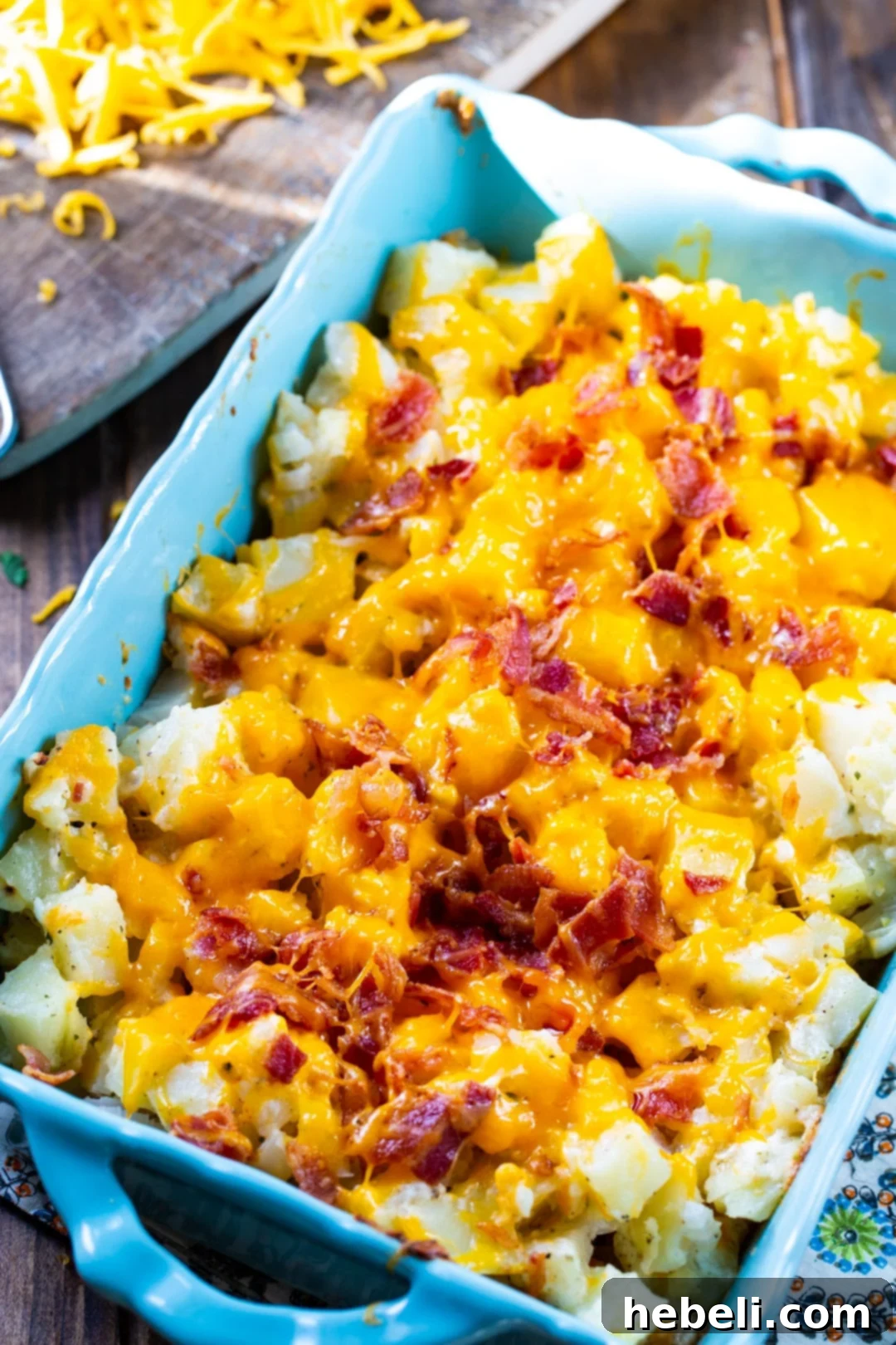 Bacon Ranch Potatoes nestled in a large ceramic baking dish, ready for the oven, showcasing the creamy texture and cheese.