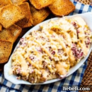 Slow Cooker Reuben Dip in a serving dish with toasted bread slices.