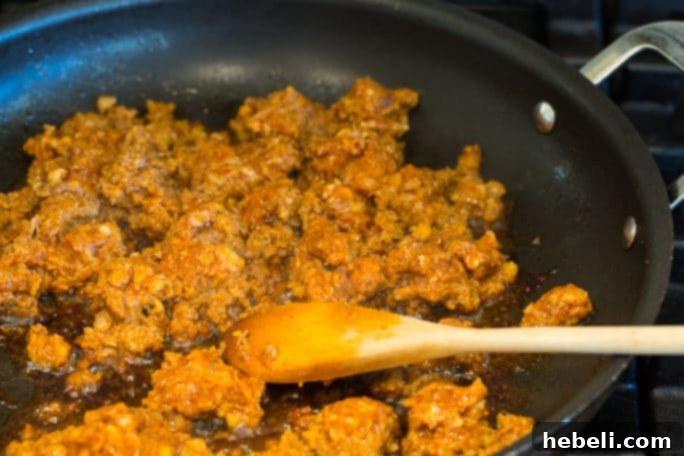 Rich and creamy Chorizo Gravy bubbling and simmering in a pan