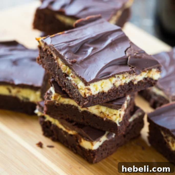 Bailey's Irish Cream Brownies - A close-up shot of a square brownie with a creamy layer and chocolate topping.