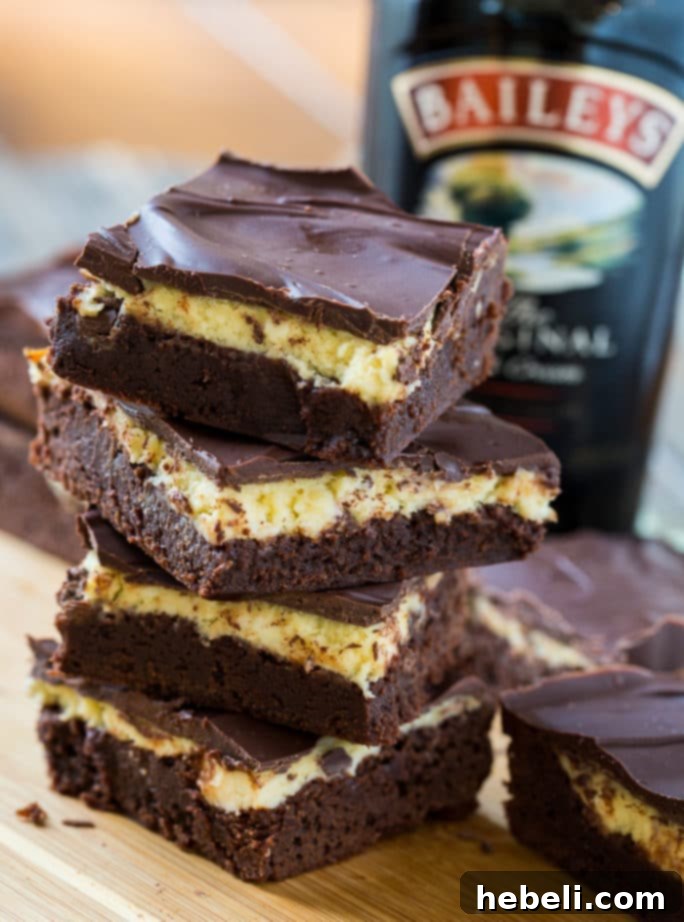 A stack of three Bailey's Irish Cream Brownies on a white plate, showing the distinct layers.