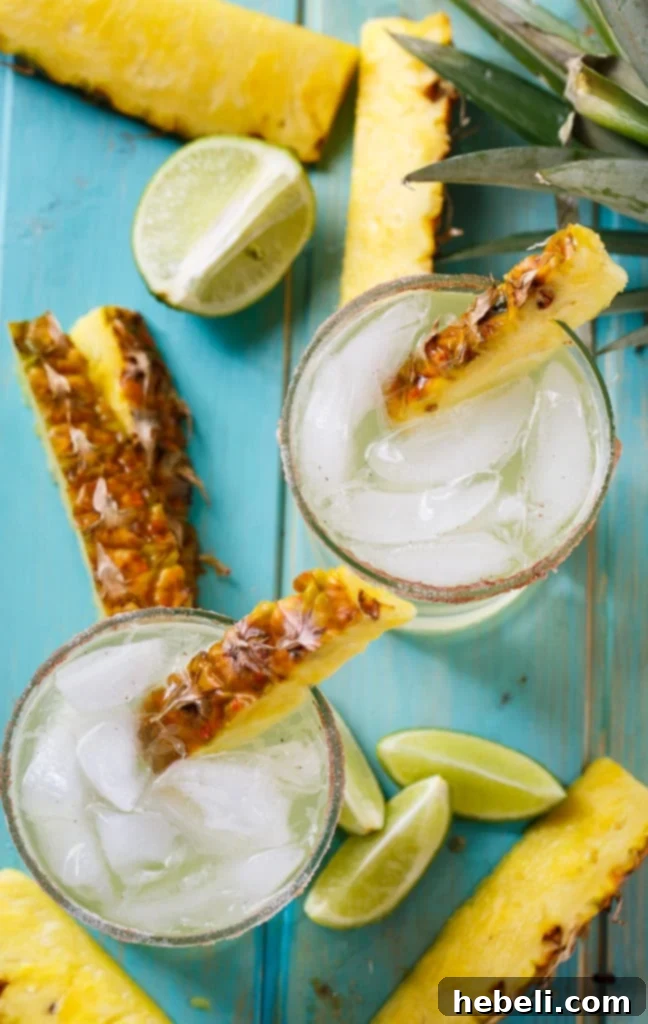 Close-up of Pineapple-Cinnamon Margarita in a glass with cinnamon sugar rim