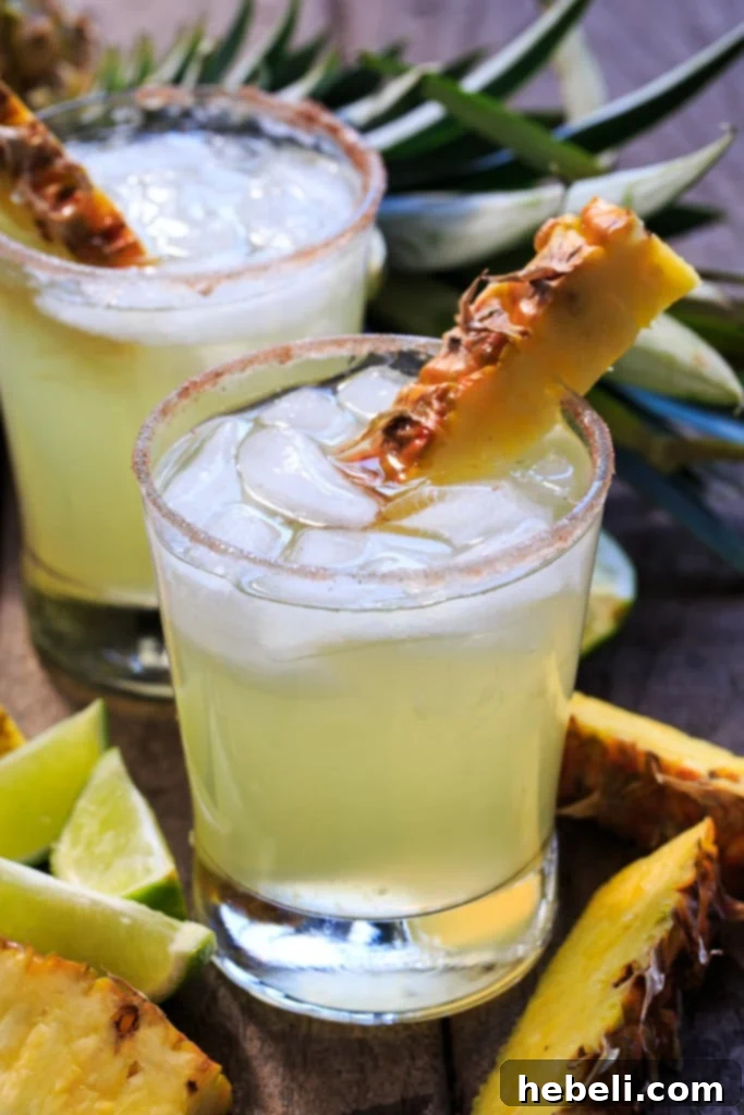 Multiple Pineapple-Cinnamon Margaritas on a tray, ready to be served