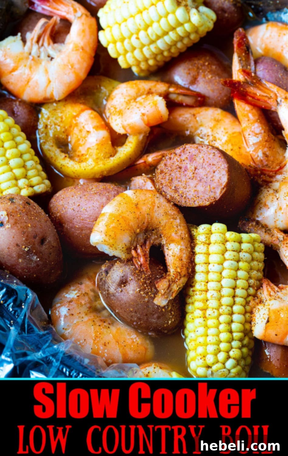 Crockpot Low Country Feast 7 A vibrant platter of Slow Cooker Low Country Boil with shrimp, sausage, potatoes, and corn, garnished with fresh herbs.