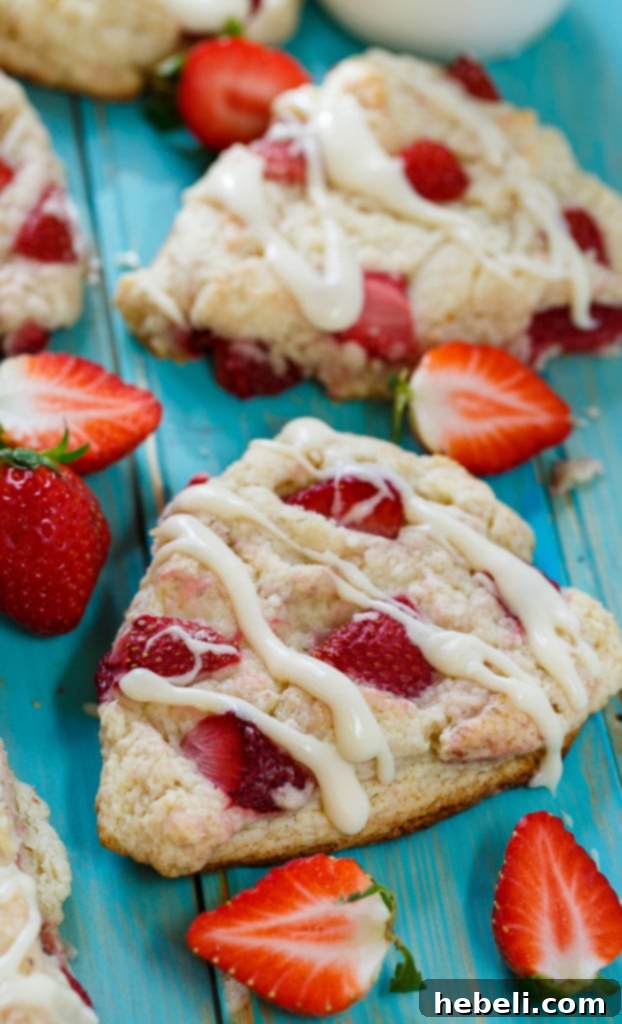 Fresh Strawberry Cream Scones 6 Multiple Strawberry and Cream Scones on a cooling rack, some with glaze.