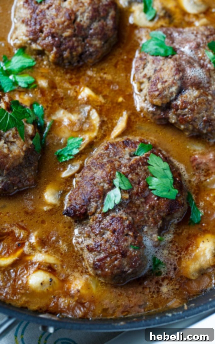 Salisbury Steak patties prepared for cooking, showcasing the tender texture achieved with onion soup mix and instant potato flakes.