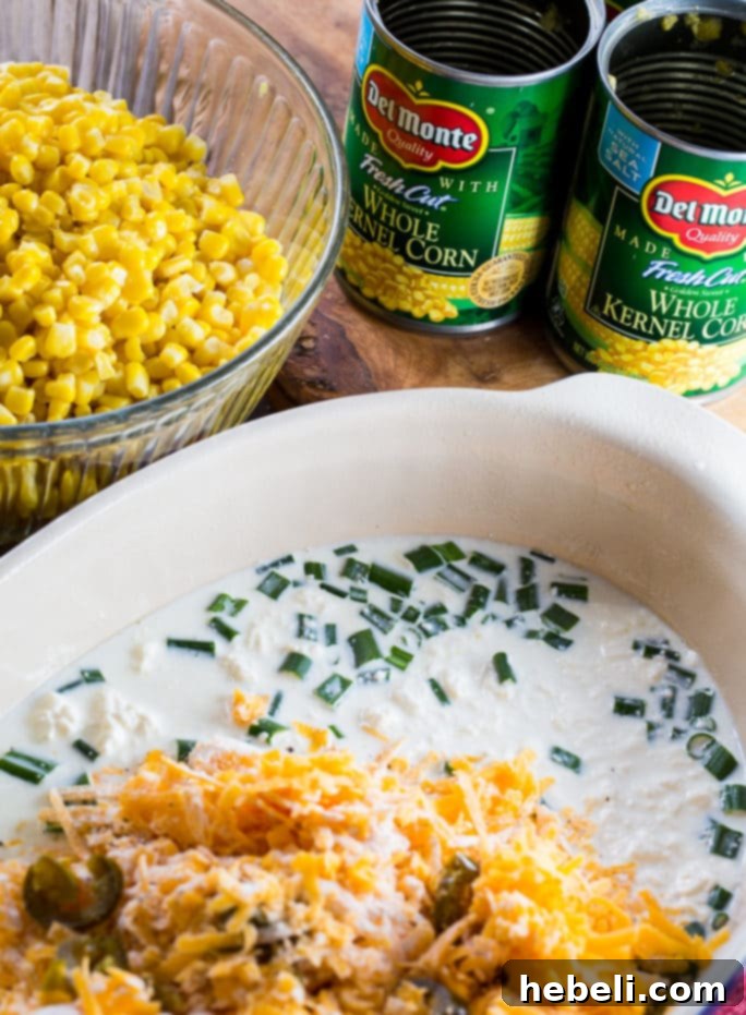 Cheddar Corn Casserole with lots of cheese and bacon, showcasing its rich texture.