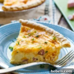 Easy Ham and Cheese Quiche slice on a blue plate.