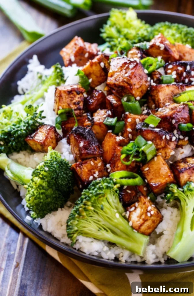 Asian Garlic Tofu sizzling in a hot cast iron pan, developing a delicious crispy crust.