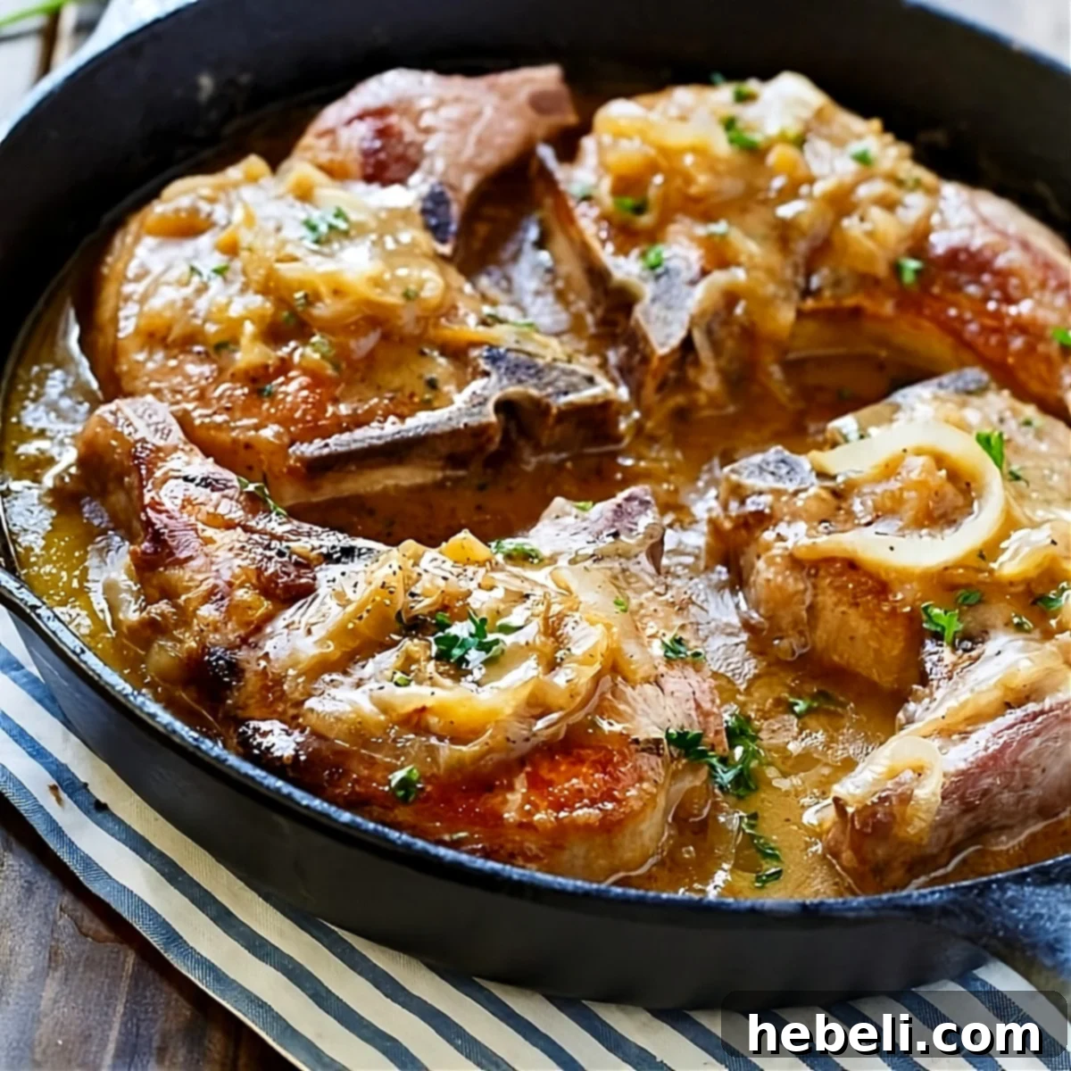 Smothered Southern Pork Chops in cast iron pan, ready to serve.