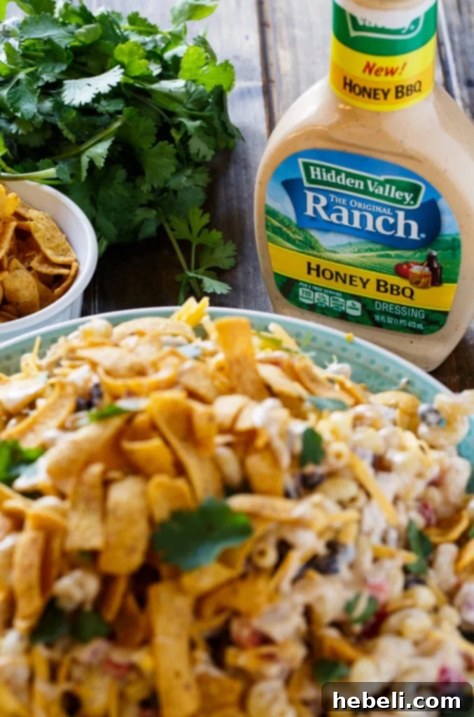 Zesty BBQ Ranch Pasta Toss 4 A beautifully arranged large bowl of BBQ Ranch Pasta Salad, garnished with fresh herbs, ready to be served at an outdoor event.