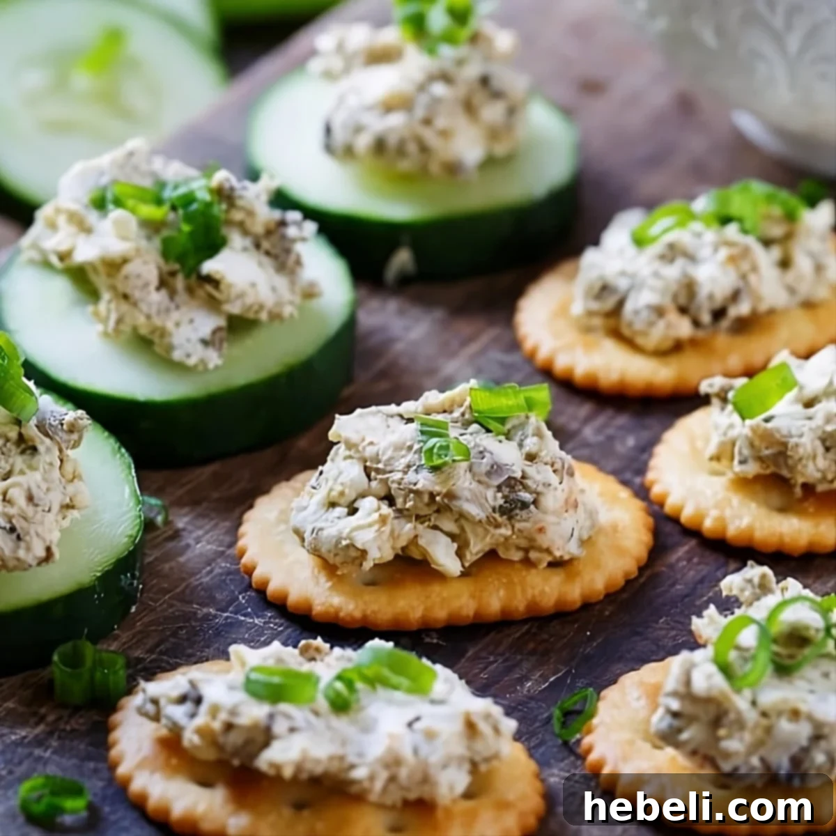 Creamy Smoked Oyster Spread served on crackers and cucumber slices, garnished for a party.
