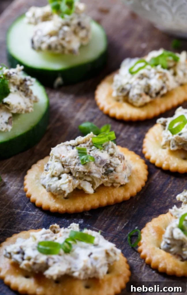 Smoked Oyster Spread served beautifully on a platter with various crackers and cucumber slices.