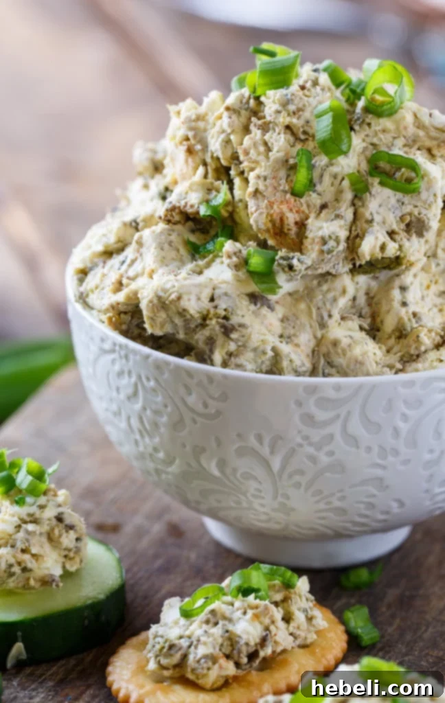 Smoked Oyster Spread in a bowl, with serving utensils nearby.