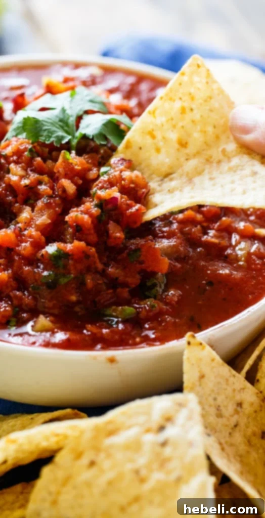 Flame-Kissed Salsa 6 A rustic bowl of fire-roasted salsa presented on a wooden board, ready to be served, highlighting its fresh appeal.