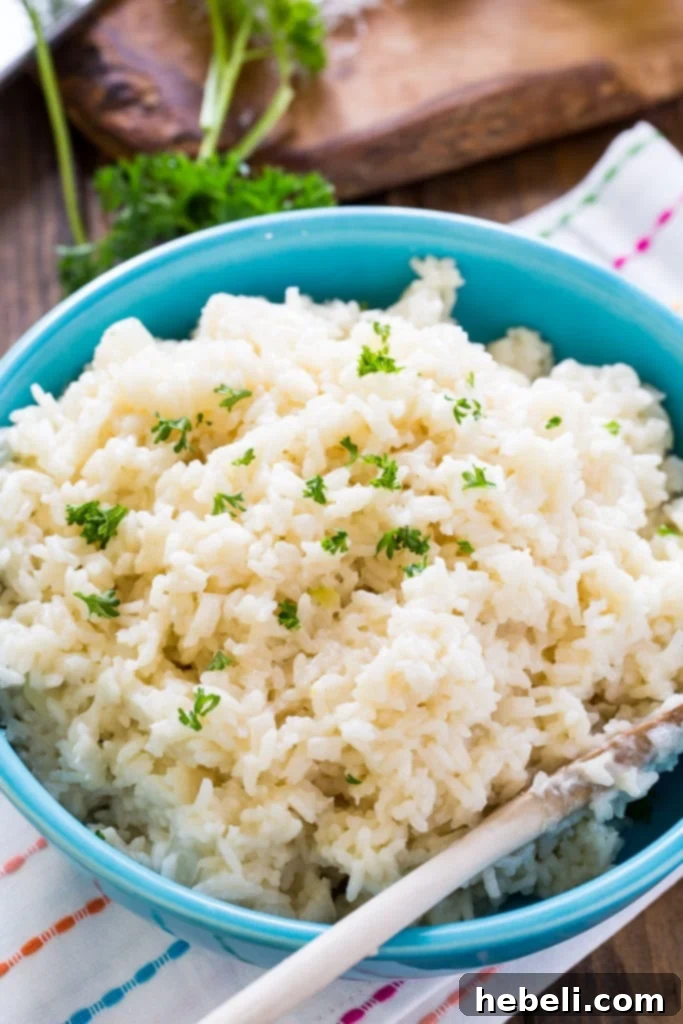 A bowl of Creamy Parmesan Rice garnished with fresh parsley.