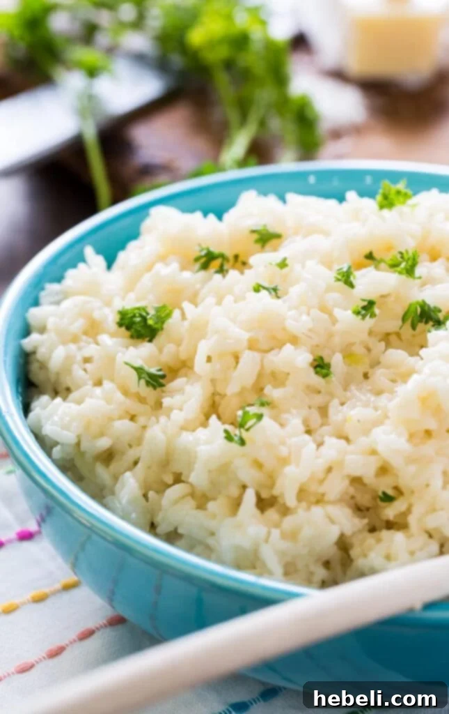 A large serving spoon scooping creamy Parmesan rice from a bowl.
