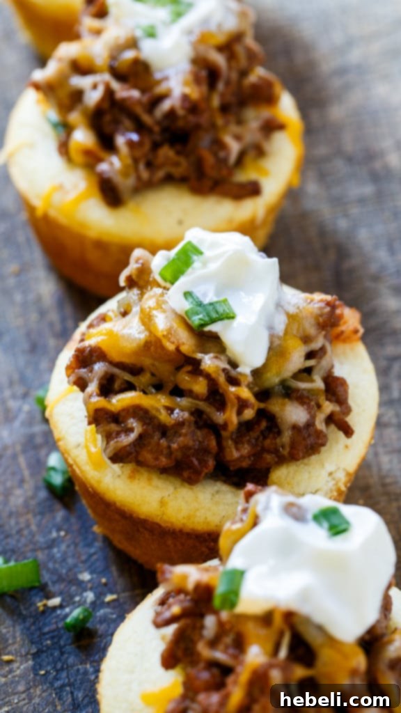Stuffed Sloppy Joe Cornbread Muffins 5 Muffin tin with cornbread batter and sloppy joe filling