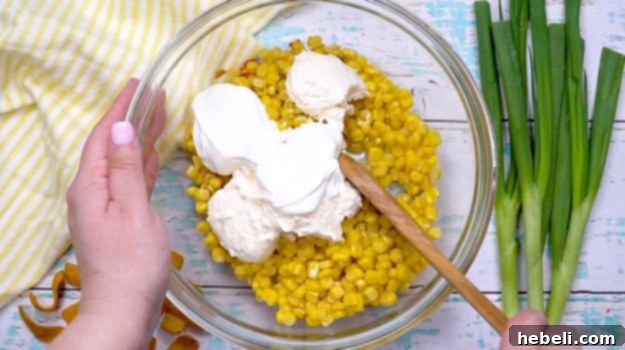Sour cream and mayonnaise added to corn mixture.