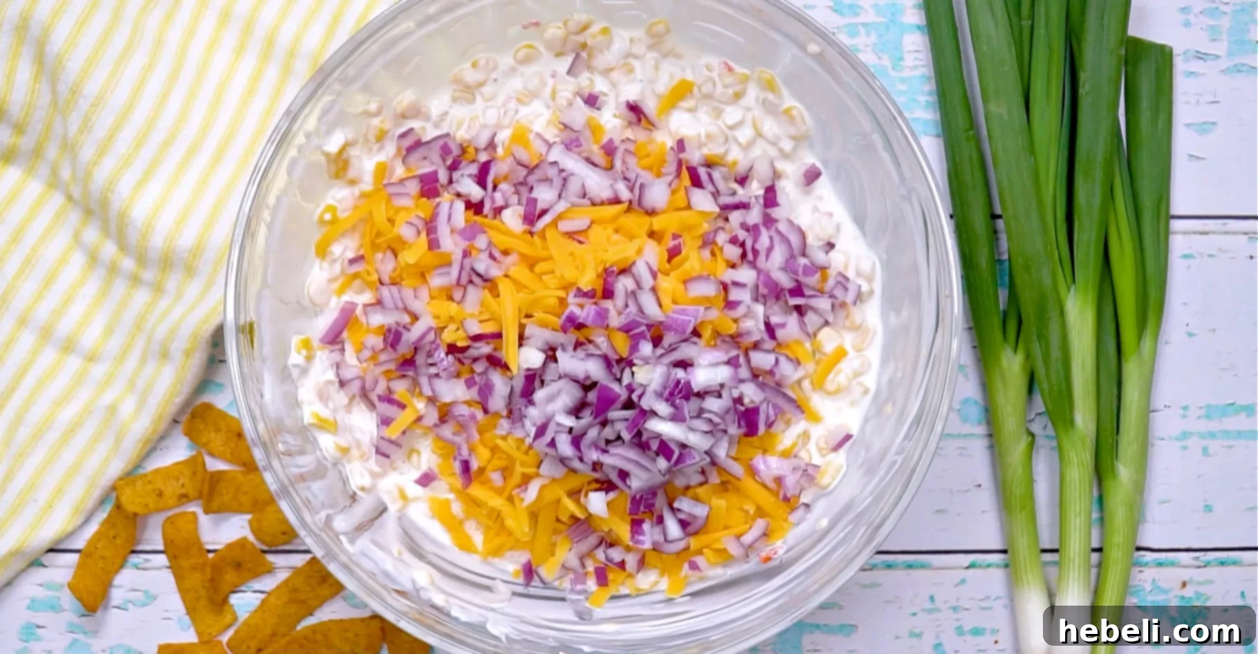 Onion and cheese being added.