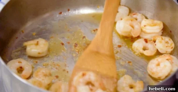 Spicy Shrimp Rose Pasta 5 Shrimp and red pepper flakes cooking together in a large pan until perfectly pink.