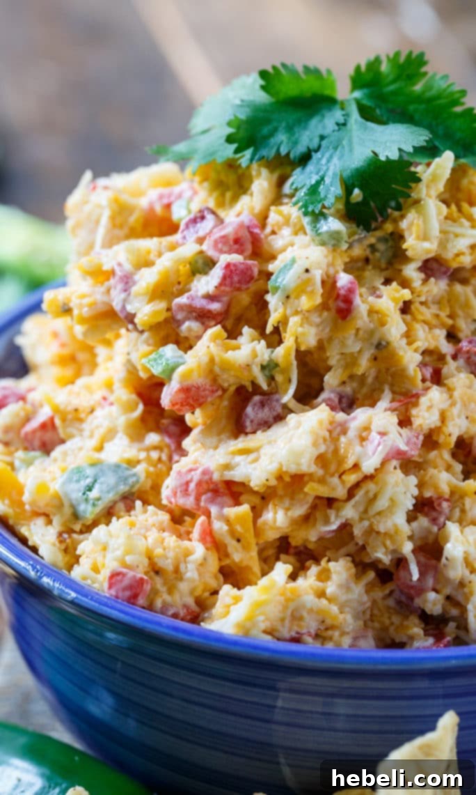Kickin' Tex-Mex Pimento Cheese 7 Delicious Tex-Mex Pimento Cheese, a spicy and flavorful Southern spread, garnished with fresh cilantro and ready to serve.
