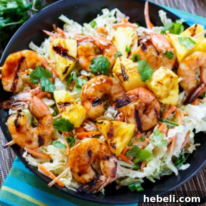 Grilled Teriyaki Shrimp Skewers with Asian Slaw featuring fresh pineapple