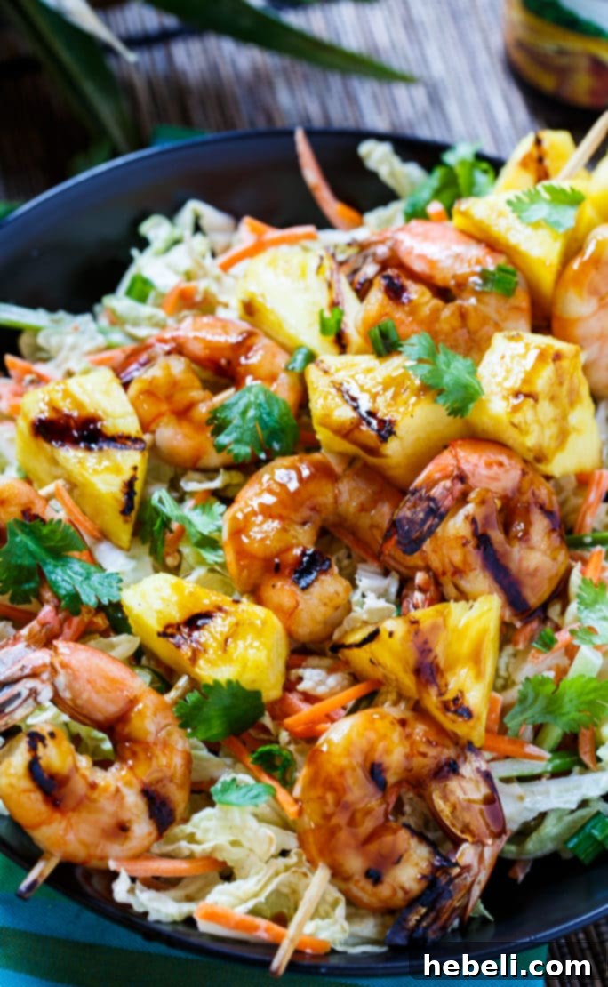 Grilled teriyaki shrimp skewers being basted on a barbecue grill