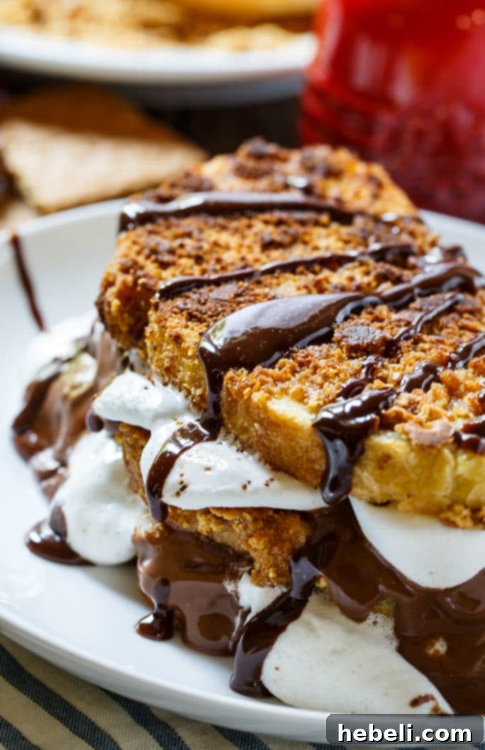 S'mores French Toast on a griddle, showcasing the graham cracker coating becoming golden and crispy