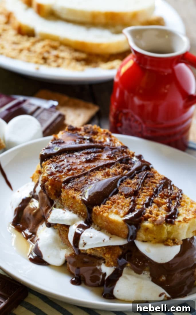 Close-up of the French toast cooking on a pan, showing the rich, golden brown crust from the graham cracker coating
