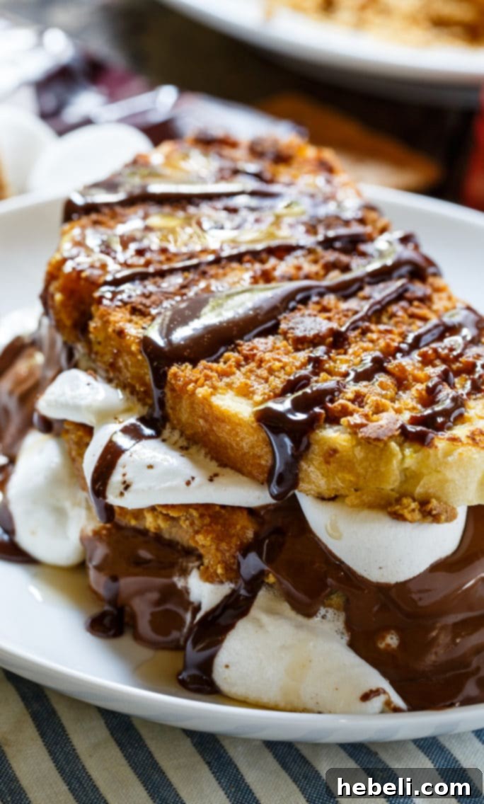 Detailed close-up of S'mores French Toast showing the crispy graham cracker coating and a glimpse of the melted chocolate and marshmallow