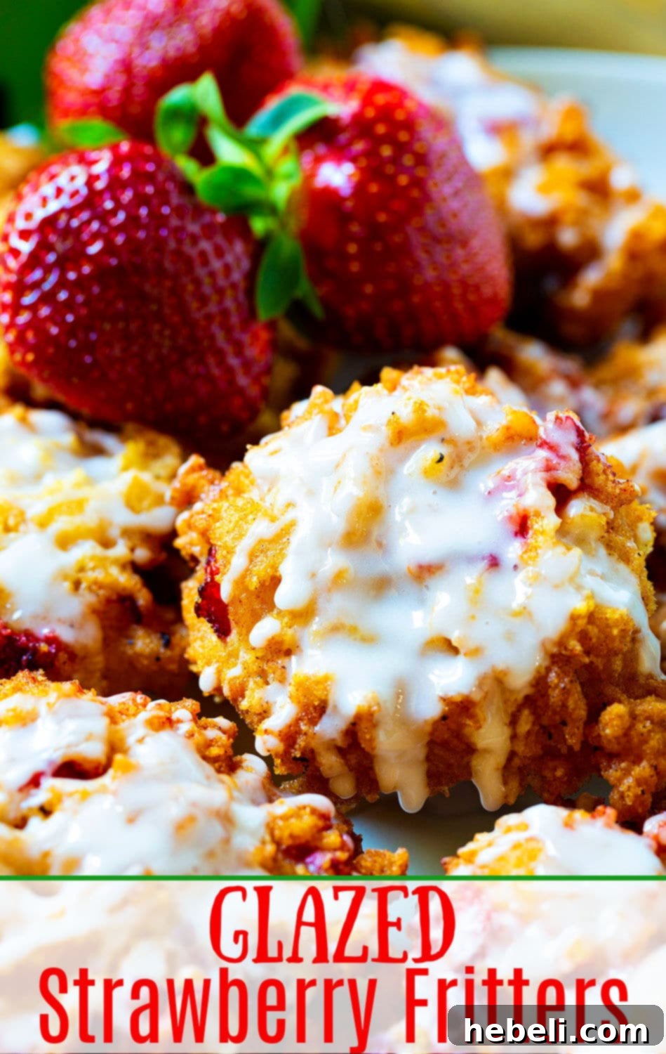 Sweet Strawberry Fritter Delights 7 A close-up of a plate piled high with Glazed Strawberry Fritters, showcasing their crispy texture and an abundance of fresh diced strawberries visible within.