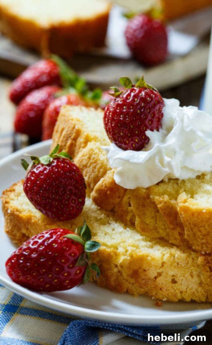 Velvet Condensed Milk Pound Cake 5 A slice of Condensed Milk Pound Cake on a plate, garnished with berries