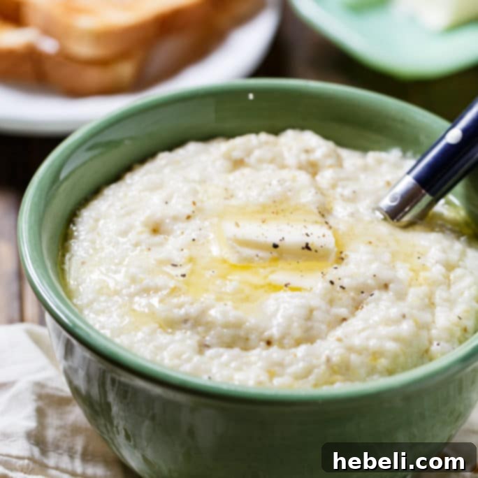 A close-up shot of incredibly creamy, smooth grits in a bowl, ready to be served, perfect for a hearty Southern breakfast.