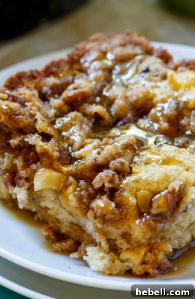 Slice of Apple Crisp Coffee Cake on a plate, showing texture and glaze