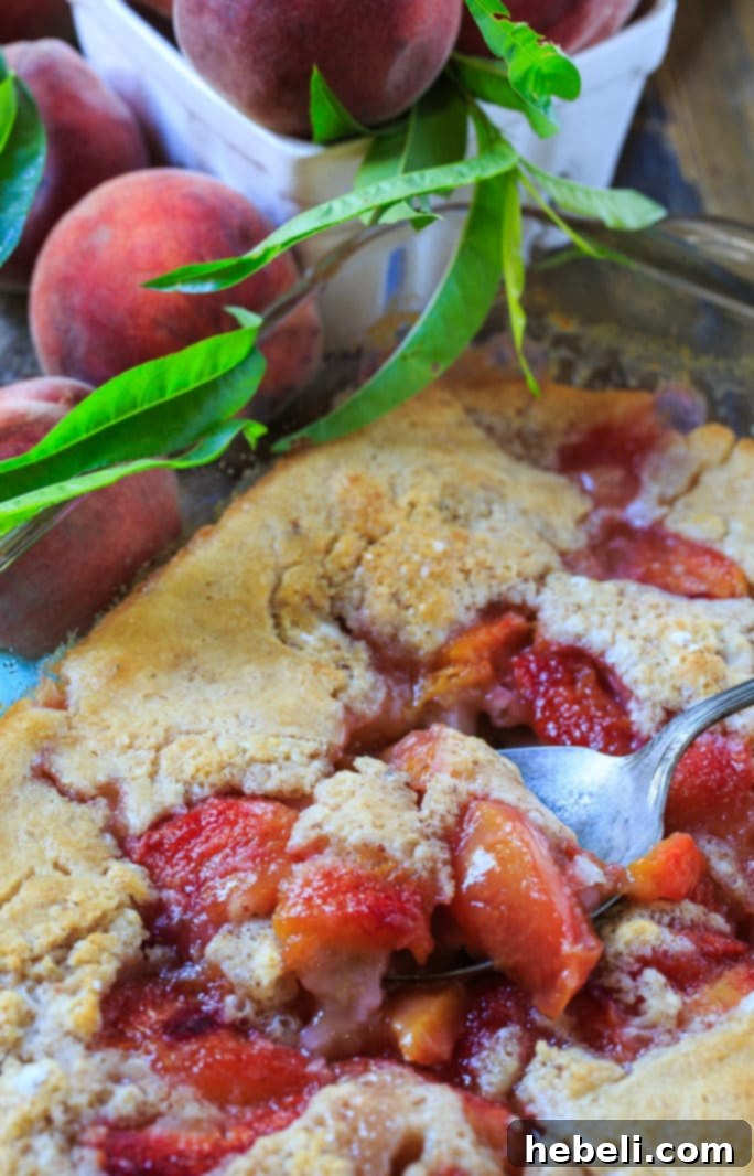 A close-up of a bowl of Easy Southern Peach Cobbler, a beloved summer dessert