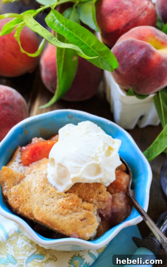 A large serving of Easy Southern Peach Cobbler with a golden brown crust
