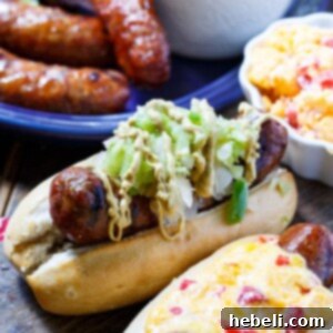 Grilled Brats topped with Pimento cheese and Green Tomato Chow Chow.
