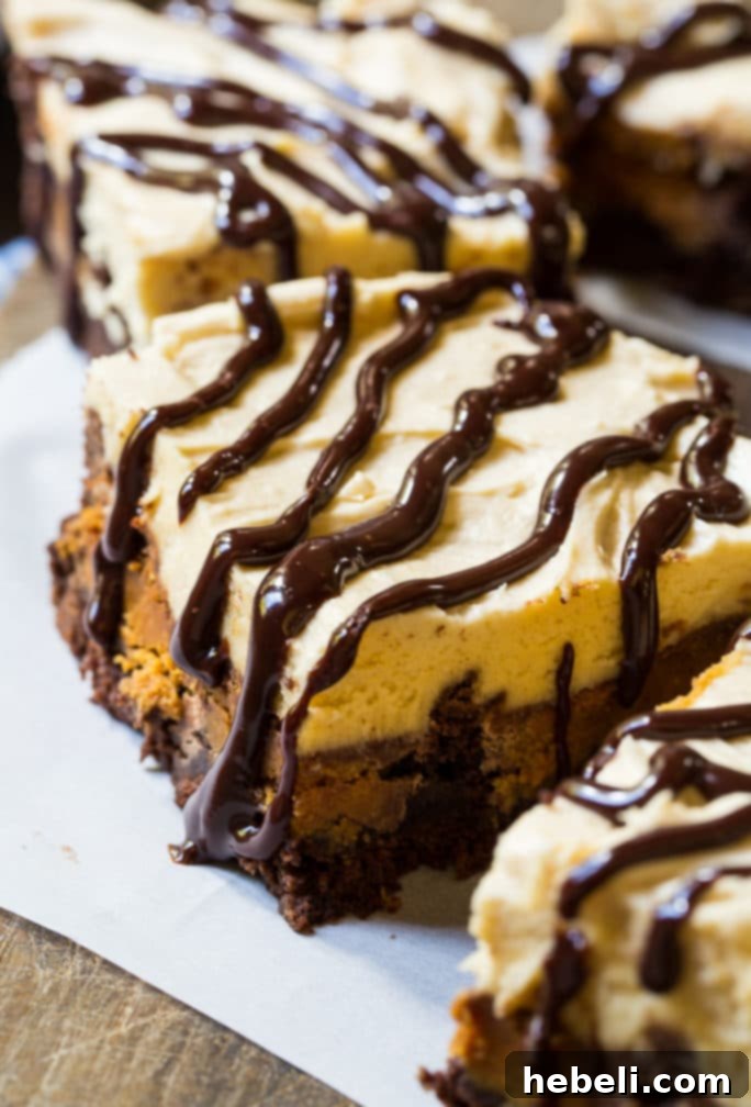 Unwrapped Reese's Peanut Butter Cups being pressed into a pan of brownie batter before baking